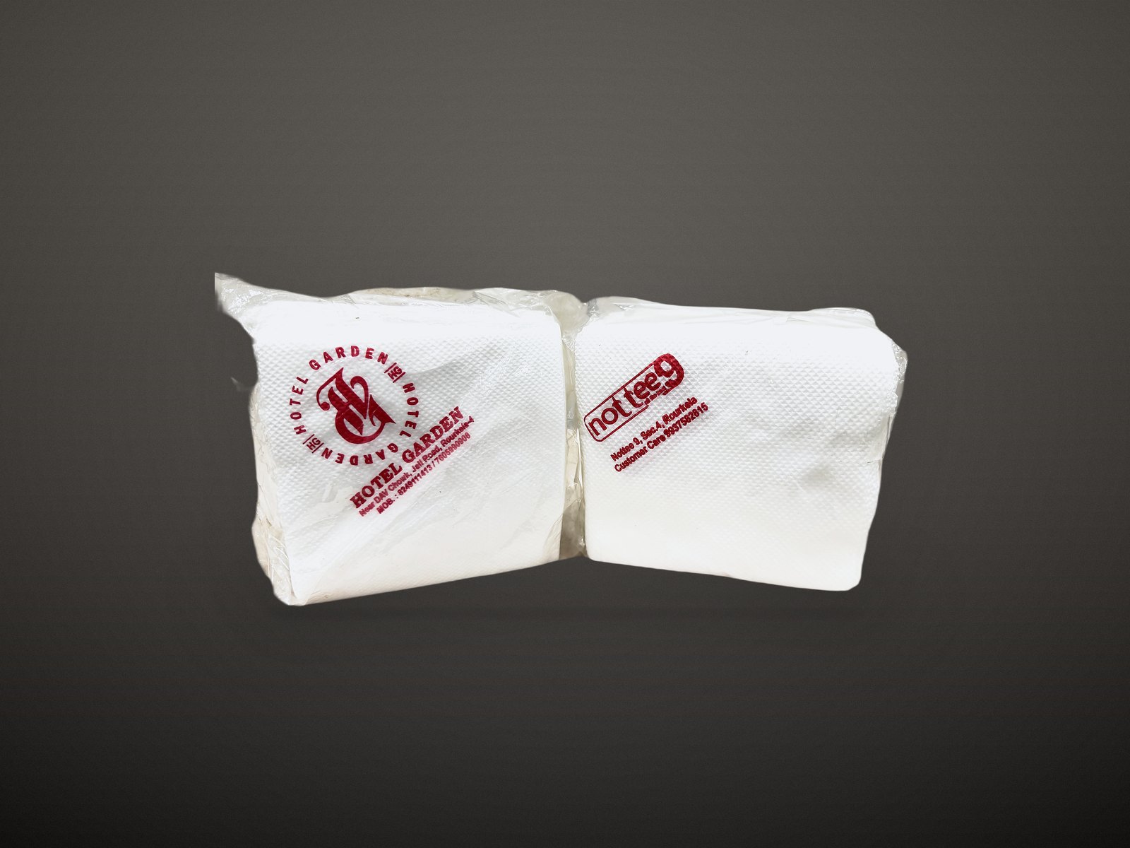 Two customer-printed white napkins showing the Hotel Garden and Nottee9 logos