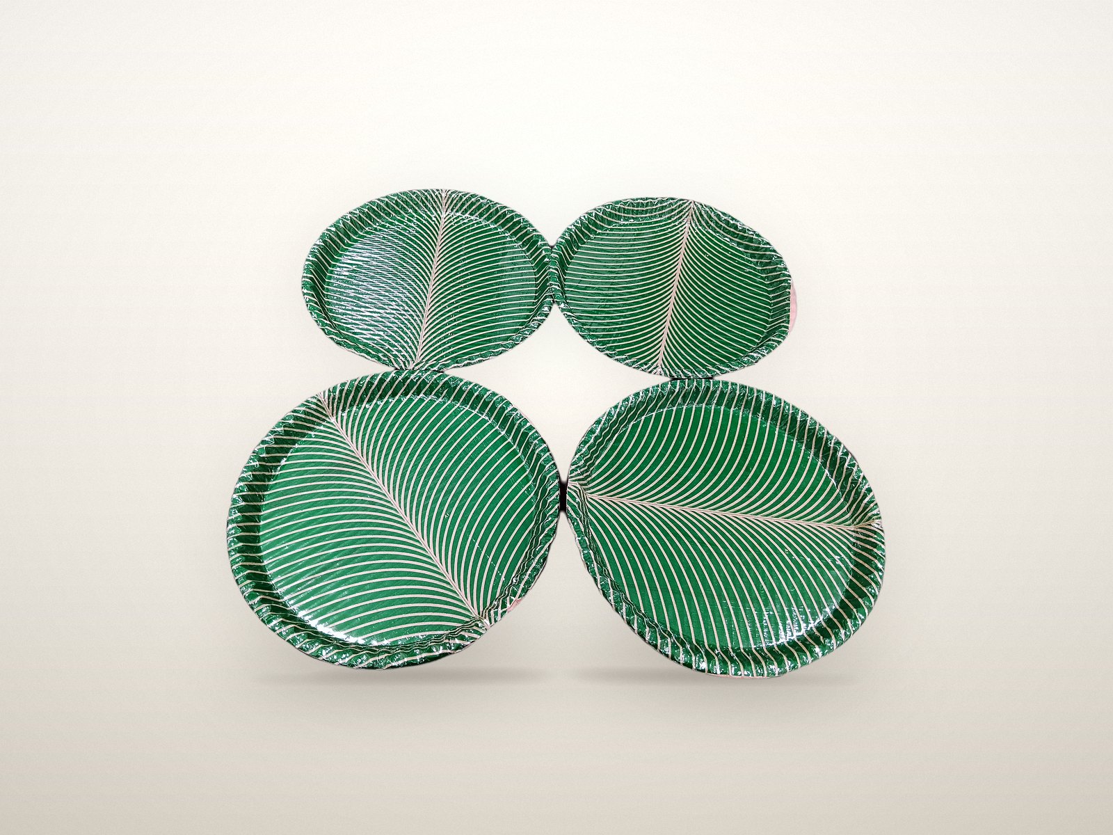 Green leaf-print paper plates in two diameters